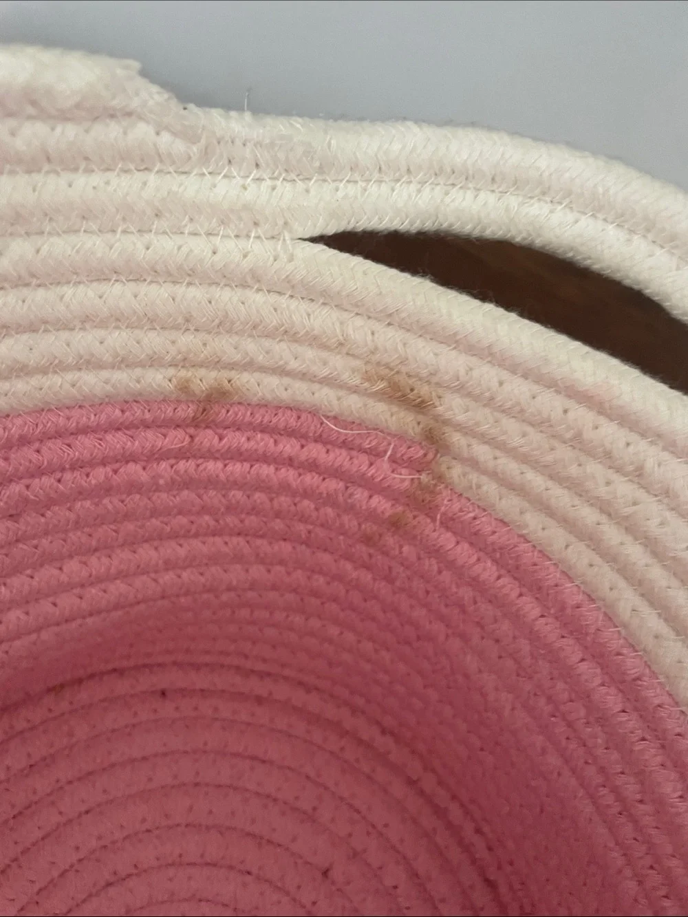 Pink and white braided basket with handles